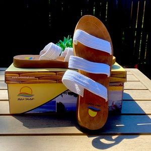 Maui Island sandals with white straps.